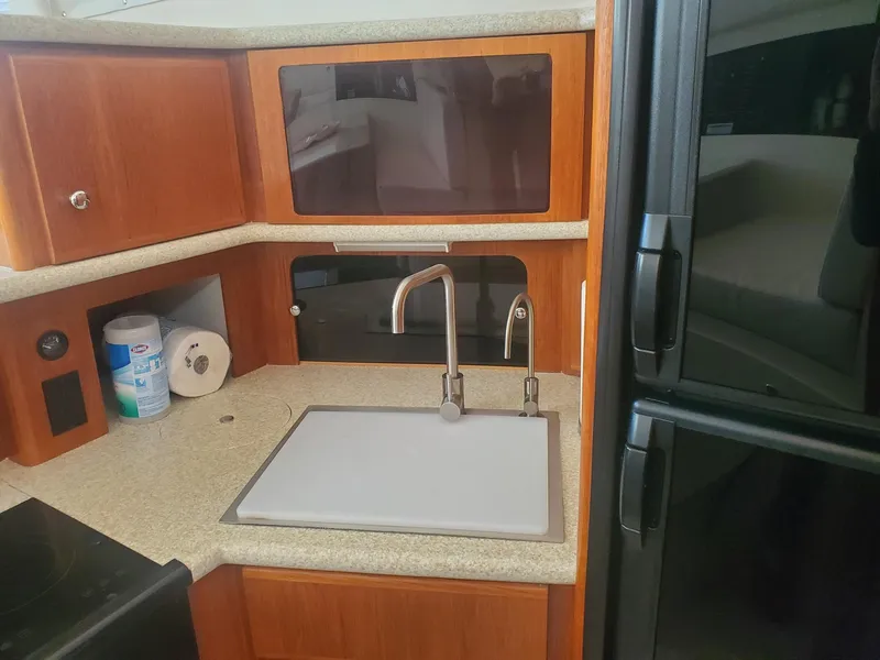 Slide: The Image of Interior of 2000 Carver 356 Aft Cabin Motor Yacht kitchen with sink and cabinets. - 32