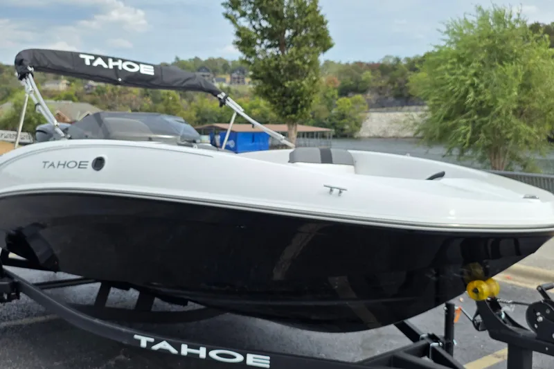 Slide: The Image of 2027 Tahoe T16 boat on trailer by a scenic lakeside. - 2