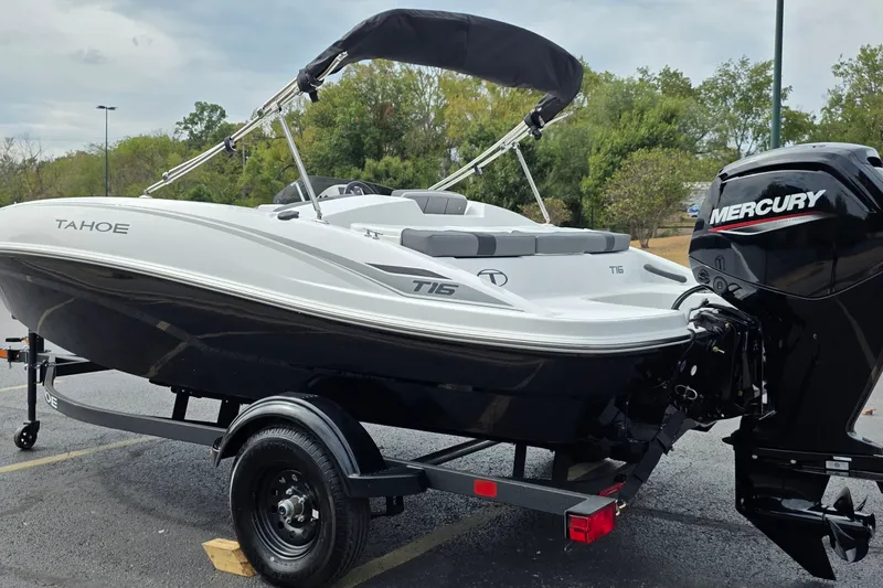 Slide: The Image of 2027 Tahoe T16 boat with Mercury engine on trailer, parked outdoors. - 68
