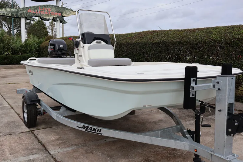 Slide: The Image of 2026 Mako Pro Skiff 13 CC boat on trailer, parked near "Live Alligators" sign. - 5