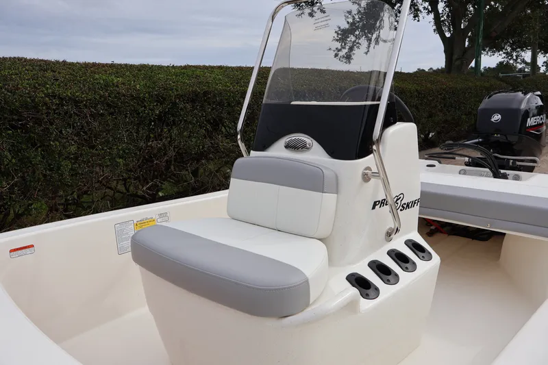Slide: The Image of 2026 Mako Pro Skiff 13 CC boat with seating and console, outdoors. - 8
