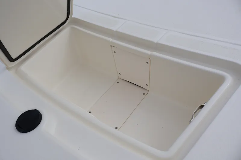 Slide: The Image of Open storage compartment on 2026 Mako Pro Skiff 13 CC boat. - 19