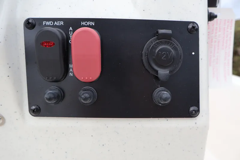 Slide: The Image of Control panel of 2026 Mako Pro Skiff 13 CC with switches and 12V outlet. - 13