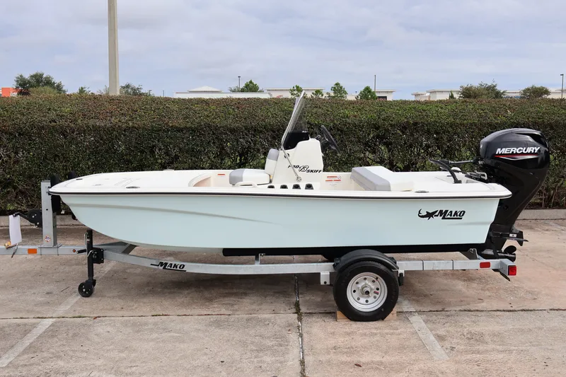 The Image of 2026 Mako Pro Skiff 13 CC boat on trailer, featuring Mercury outboard motor. - 0