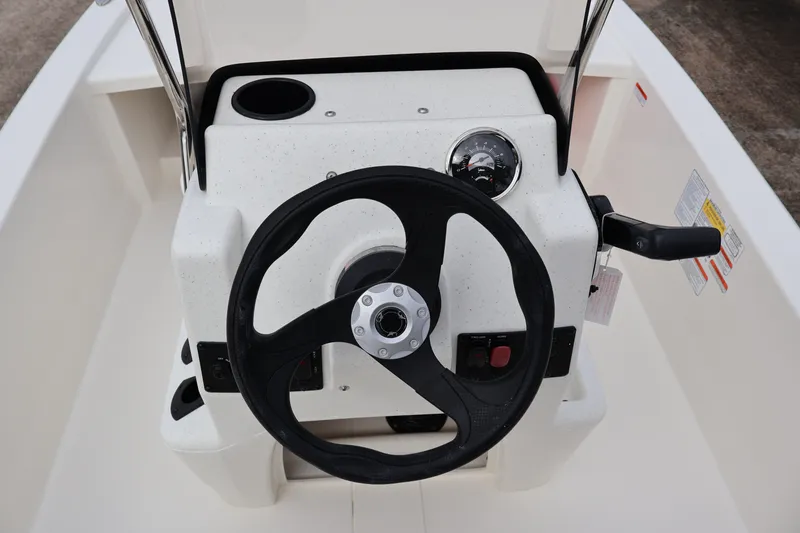 Slide: The Image of Steering console of 2026 Mako Pro Skiff 13 CC boat with gauge and controls. - 11
