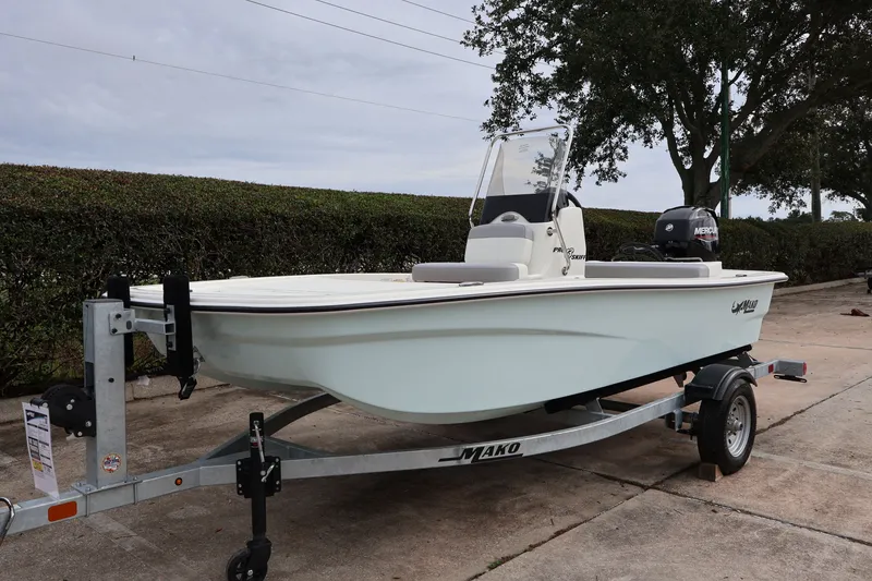 Slide: The Image of 2026 Mako Pro Skiff 13 CC boat on trailer, parked outdoors. - 2