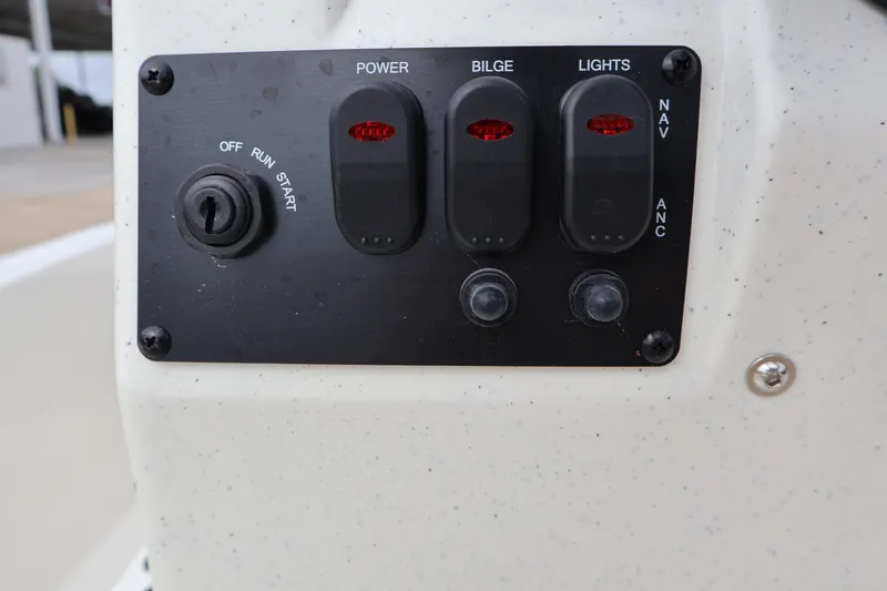 Slide: The Image of Control panel of 2026 Mako Pro Skiff 13 CC boat with switches and ignition. - 14