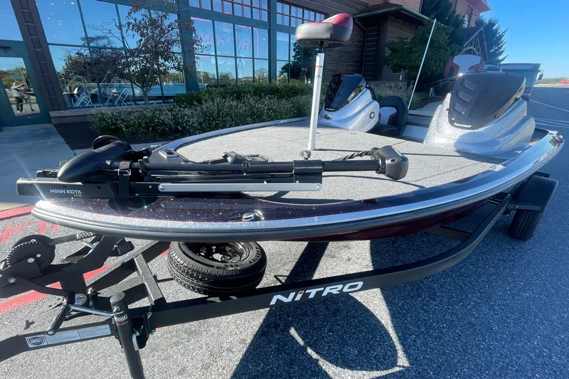 Slide: The Image of 2027 Nitro Z17 boat with Minn Kota trolling motor on a trailer, parked outdoors. - 3