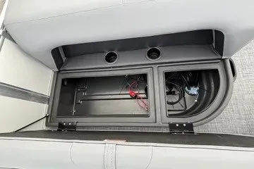 Slide: The Image of 2027 Sun Tracker Party Barge 18 DLX storage compartment with wiring and cup holders. - 14