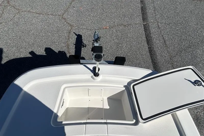 Slide: The Image of 2026 Mako Pro Skiff 13 CC boat deck with open storage compartment. - 8