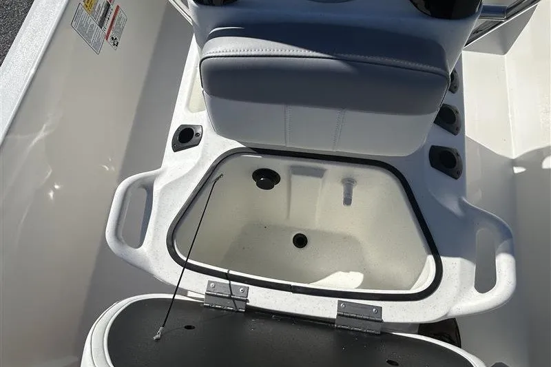 Slide: The Image of 2026 Mako Pro Skiff 13 CC boat interior with open storage compartment. - 10