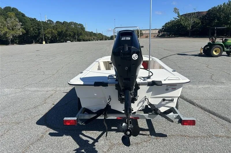 Slide: The Image of 2026 Mako Pro Skiff 13 CC boat on trailer, rear view with outboard motor. - 5