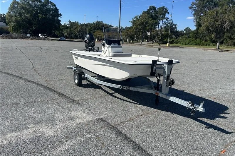 Slide: The Image of 2026 Mako Pro Skiff 13 CC boat on trailer in parking lot. - 2