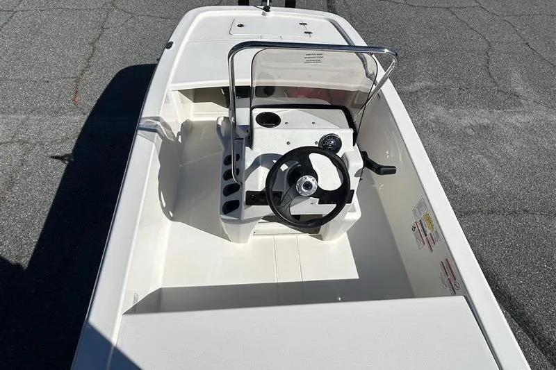 Slide: The Image of 2026 Mako Pro Skiff 13 CC boat, top view of steering console and seating. - 7