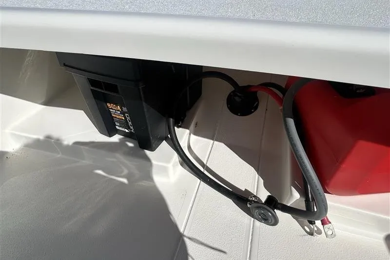 Slide: The Image of 2026 Mako Pro Skiff 13 CC boat interior showing battery and wiring setup. - 6