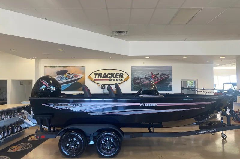 Slide: The Image of 2026 Ranger VS1882SC Reata boat displayed in a Tracker Boats showroom. - 1