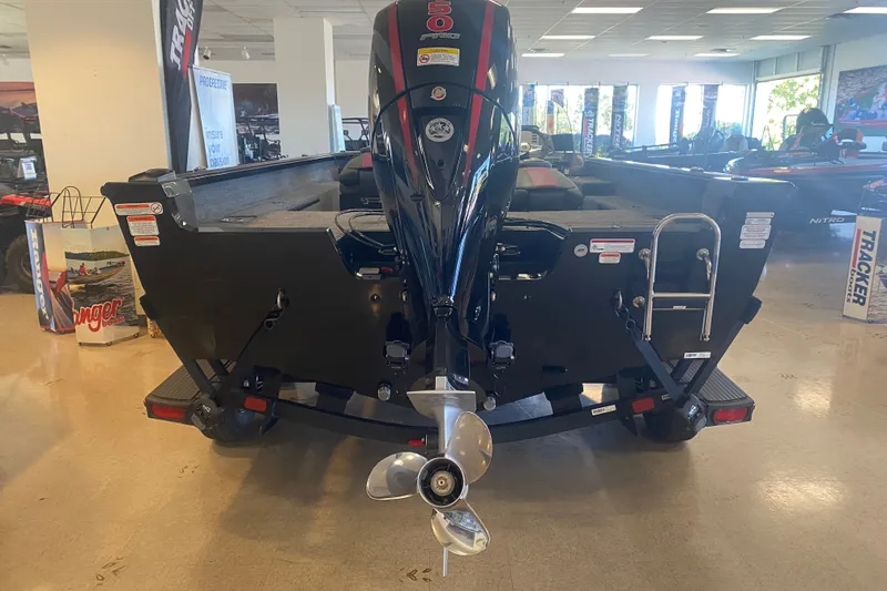 Slide: The Image of 2026 Ranger VS1882SC Reata boat displayed indoors, showcasing rear motor and ladder. - 12