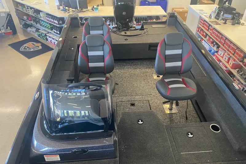 Slide: The Image of 2026 Ranger VS1882SC Reata boat interior with seating and console in showroom. - 10