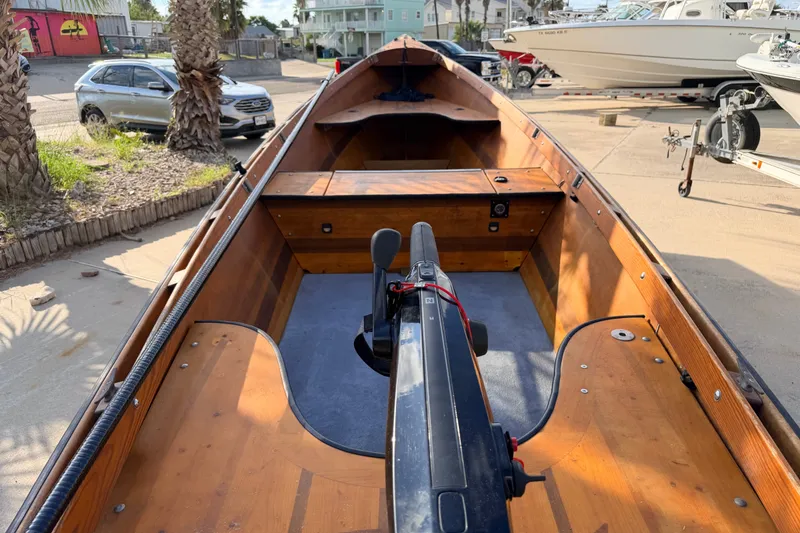 Slide: The Image of Homemade 2015 Jetdrive Skiff with wooden interior, parked near palm trees and other boats. - 4