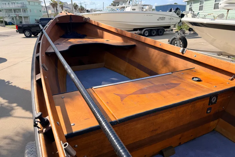 Slide: The Image of Wooden Homemade Jetdrive Skiff boat, 2015 model, docked with fish design on deck. - 7