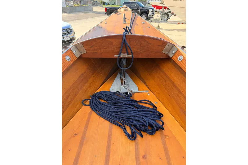 Slide: The Image of Wooden interior of a 2015 Homemade Jetdrive Skiff with coiled navy rope. - 12
