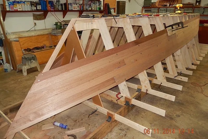Slide: The Image of Homemade Jetdrive Skiff under construction in a workshop, showcasing wooden framework and tools. - 24