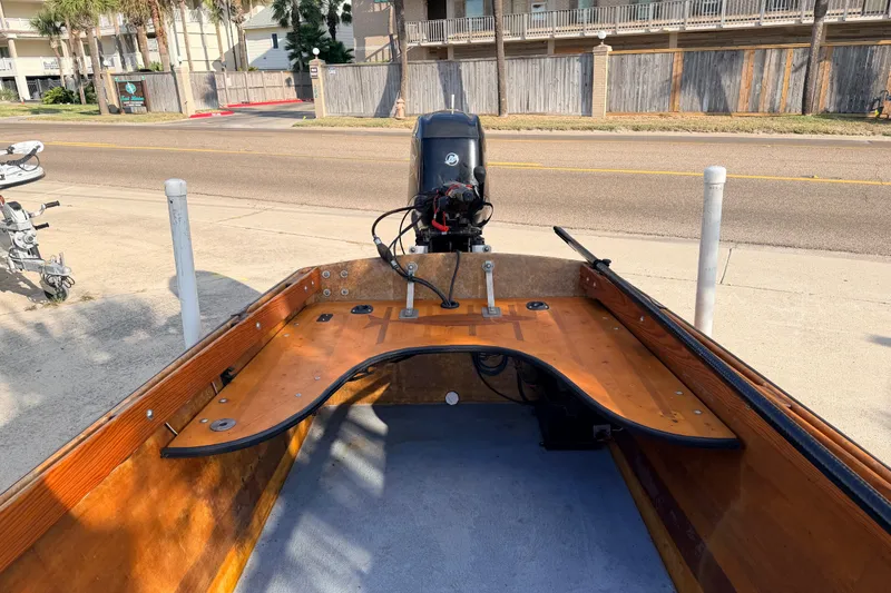 Slide: The Image of Homemade 2015 Jetdrive Skiff with wooden interior and outboard motor on a sunny street. - 16