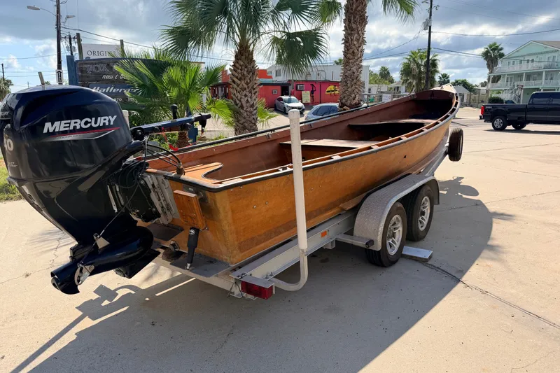 Slide: The Image of Homemade 2015 Jetdrive Skiff on trailer with Mercury outboard motor, parked outdoors. - 3