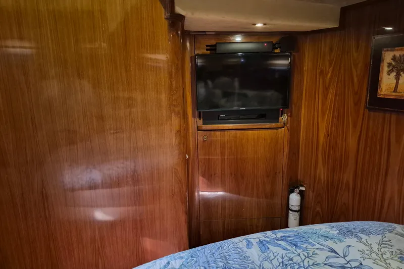 Slide: The Image of 2003 Navigator Californian Veneti interior with wood paneling, TV, and fire extinguisher. - 47