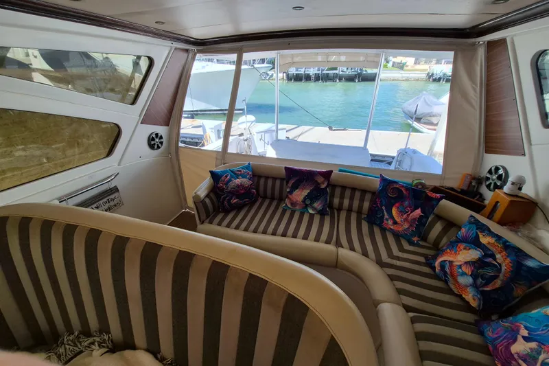 Slide: The Image of Interior of 2003 Navigator Californian Veneti yacht with striped seating and colorful pillows. - 17