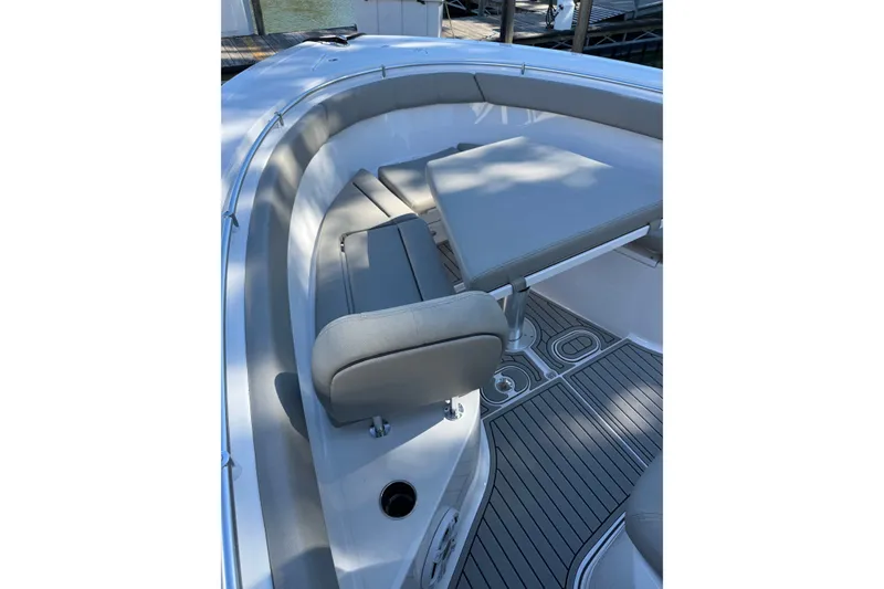 Slide: The Image of 2024 Sportsman Open 302 Center Console boat interior with cushioned seating and sleek flooring. - 20