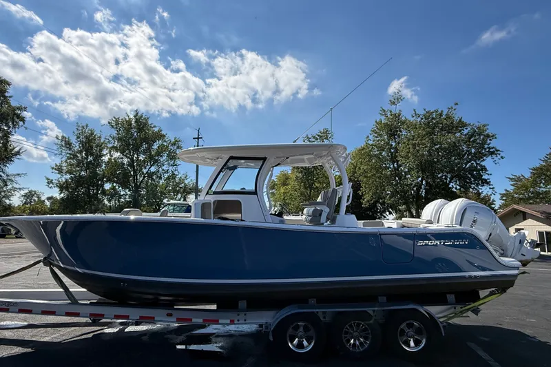 Slide: The Image of 2024 Sportsman Open 302 Center Console boat on trailer under blue sky. - 22