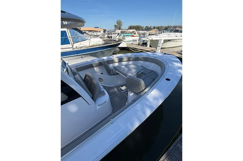 Slide: The Image of 2024 Sportsman Open 302 Center Console boat docked, featuring spacious seating and sleek design. - 13