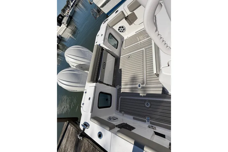 Slide: The Image of 2024 Sportsman Open 302 Center Console boat with dual engines docked at marina. - 15