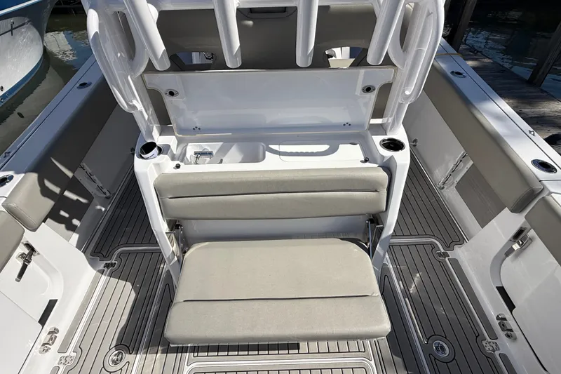 Slide: The Image of 2024 Sportsman Open 302 Center Console boat interior with seating and rod holders. - 17