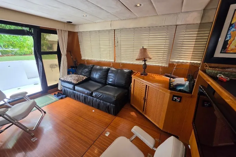 Slide: The Image of Interior of 1993 McKinna 48 Pilothouse yacht with leather sofa and wooden cabinetry. - 23