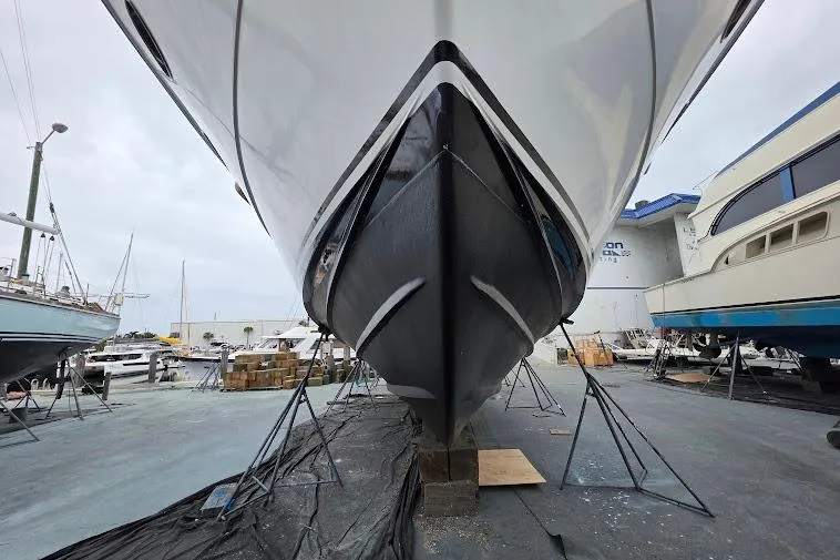 Slide: The Image of 1993 McKinna 48 Pilothouse yacht in dry dock, showcasing its sleek hull design. - 112