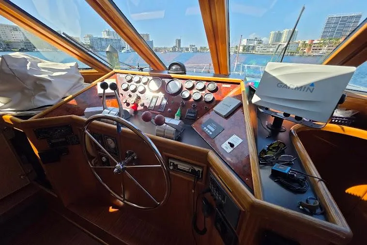 Slide: The Image of Pilothouse of 1993 McKinna 48, featuring steering wheel, controls, and Garmin navigation system. - 36