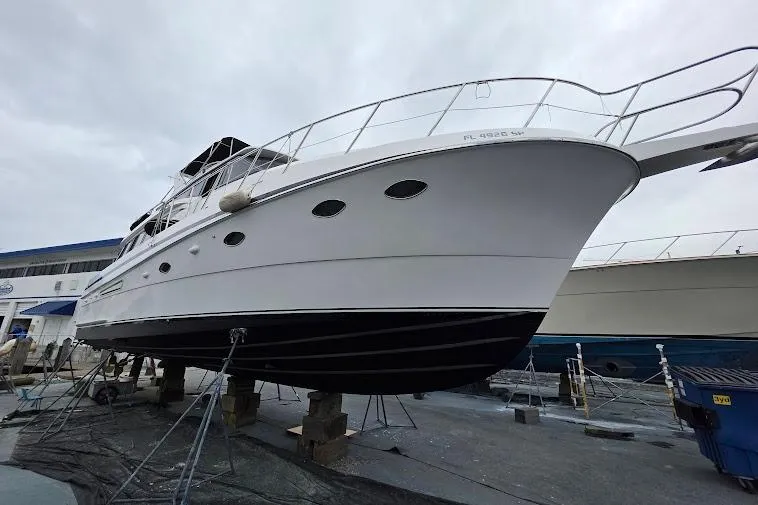 Slide: The Image of 1993 McKinna 48 Pilothouse yacht on dry dock, showcasing sleek design and sturdy construction. - 114