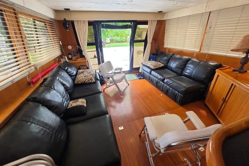 Slide: The Image of Luxurious interior of a 1993 McKinna 48 Pilothouse yacht with leather seating and wood flooring. - 19