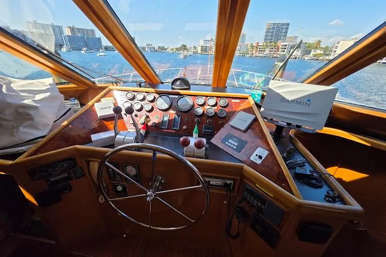 Slide: The Image of Pilothouse interior of 1993 McKinna 48, featuring steering wheel and navigation equipment. - 38