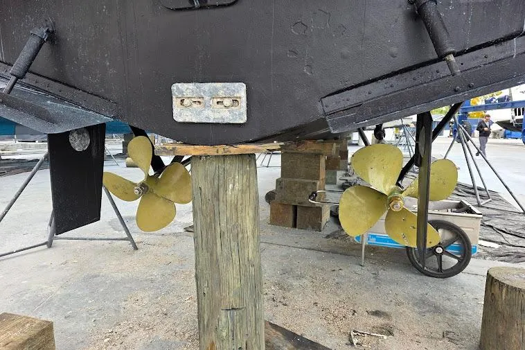 Slide: The Image of 1993 McKinna 48 Pilothouse boat propellers and rudders during maintenance. - 106