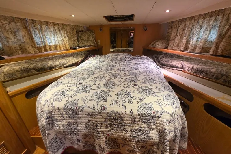 Slide: The Image of Cozy bedroom interior of 1993 McKinna 48 Pilothouse with floral bedding and wood accents. - 62