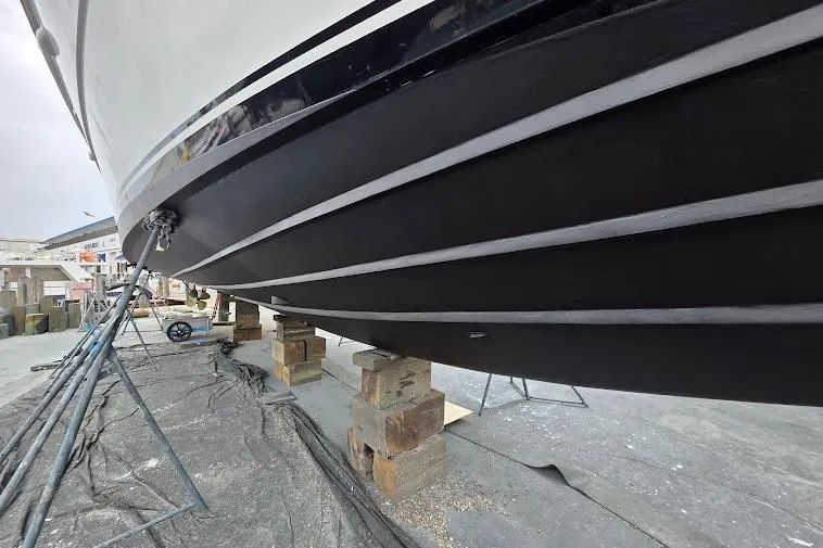 Slide: The Image of 1993 McKinna 48 Pilothouse boat hull on dry dock for maintenance. - 113