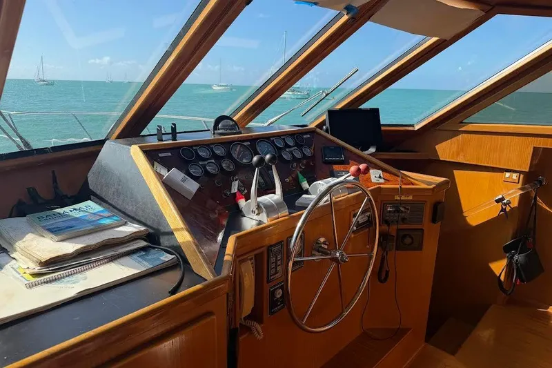 Slide: The Image of Pilothouse interior of 1993 McKinna 48, featuring steering wheel and navigation instruments. - 122