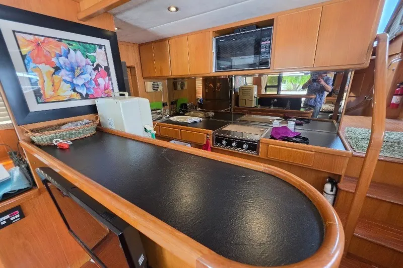 Slide: The Image of Interior of 1993 McKinna 48 Pilothouse with kitchen and colorful artwork. - 131