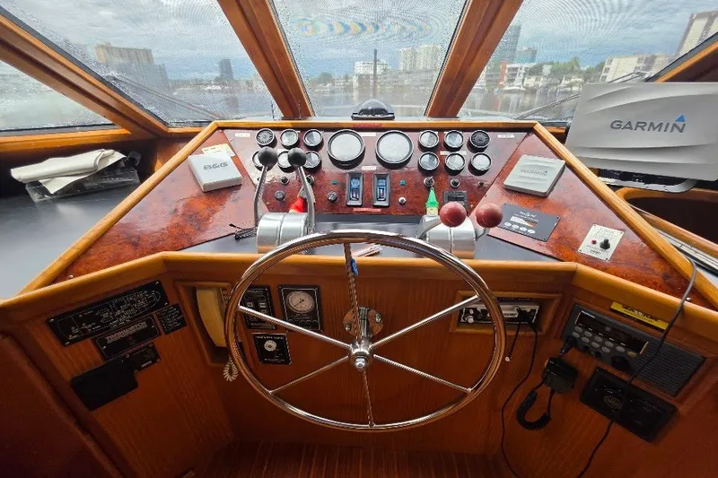 Slide: The Image of Pilothouse of 1993 McKinna 48 with steering wheel, gauges, and navigation equipment. - 136
