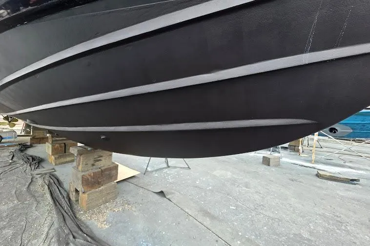 Slide: The Image of 1993 McKinna 48 Pilothouse boat hull on blocks in a shipyard. - 119