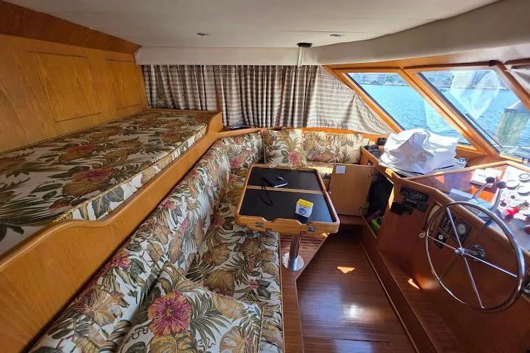 Slide: The Image of 1993 McKinna 48 Pilothouse interior with floral upholstery and wooden accents. - 34