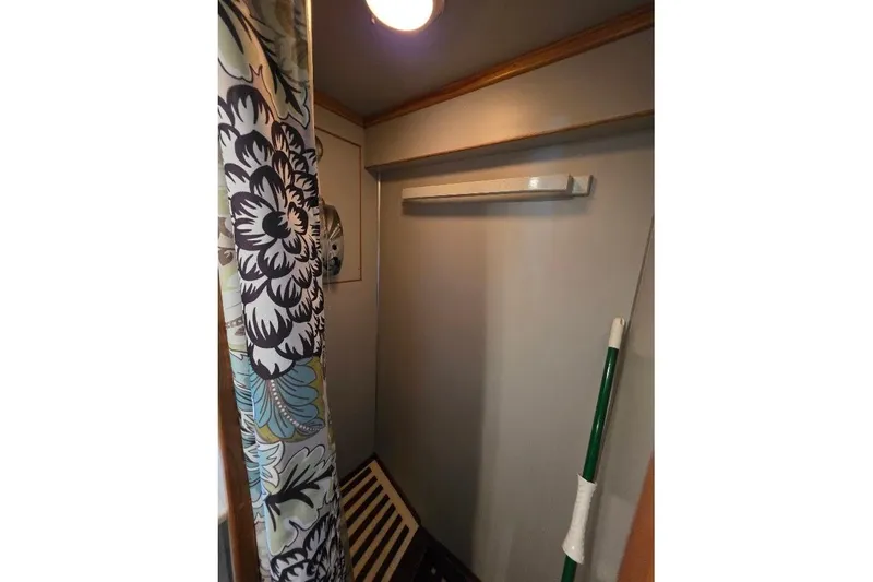 Slide: The Image of Shower area in 1993 McKinna 48 Pilothouse with floral curtain and wooden accents. - 49
